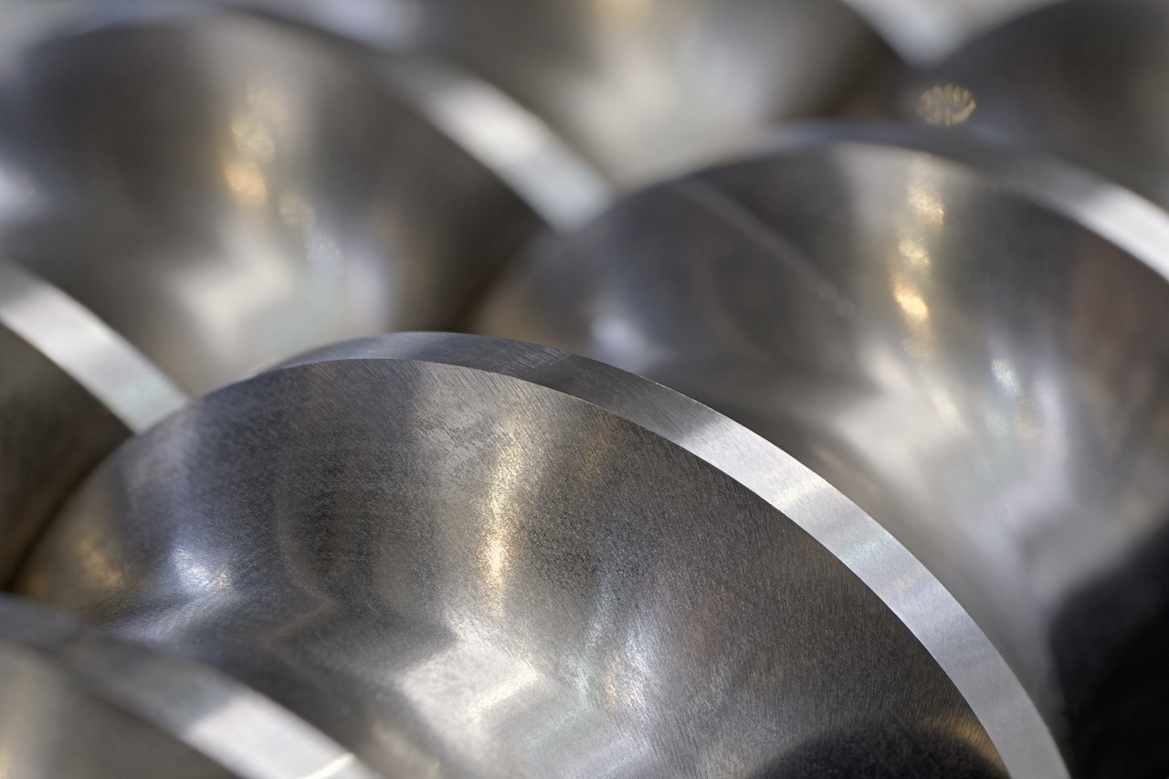 Steel helical pump, compressor, conveyor close-up shot, selective focus, abstract metal industrial background