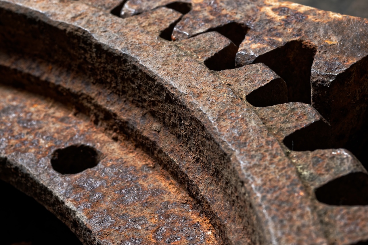 Backgrounds and textures: two connected steel cogwheels, very old and rusty, close-up shot, industrial abstract