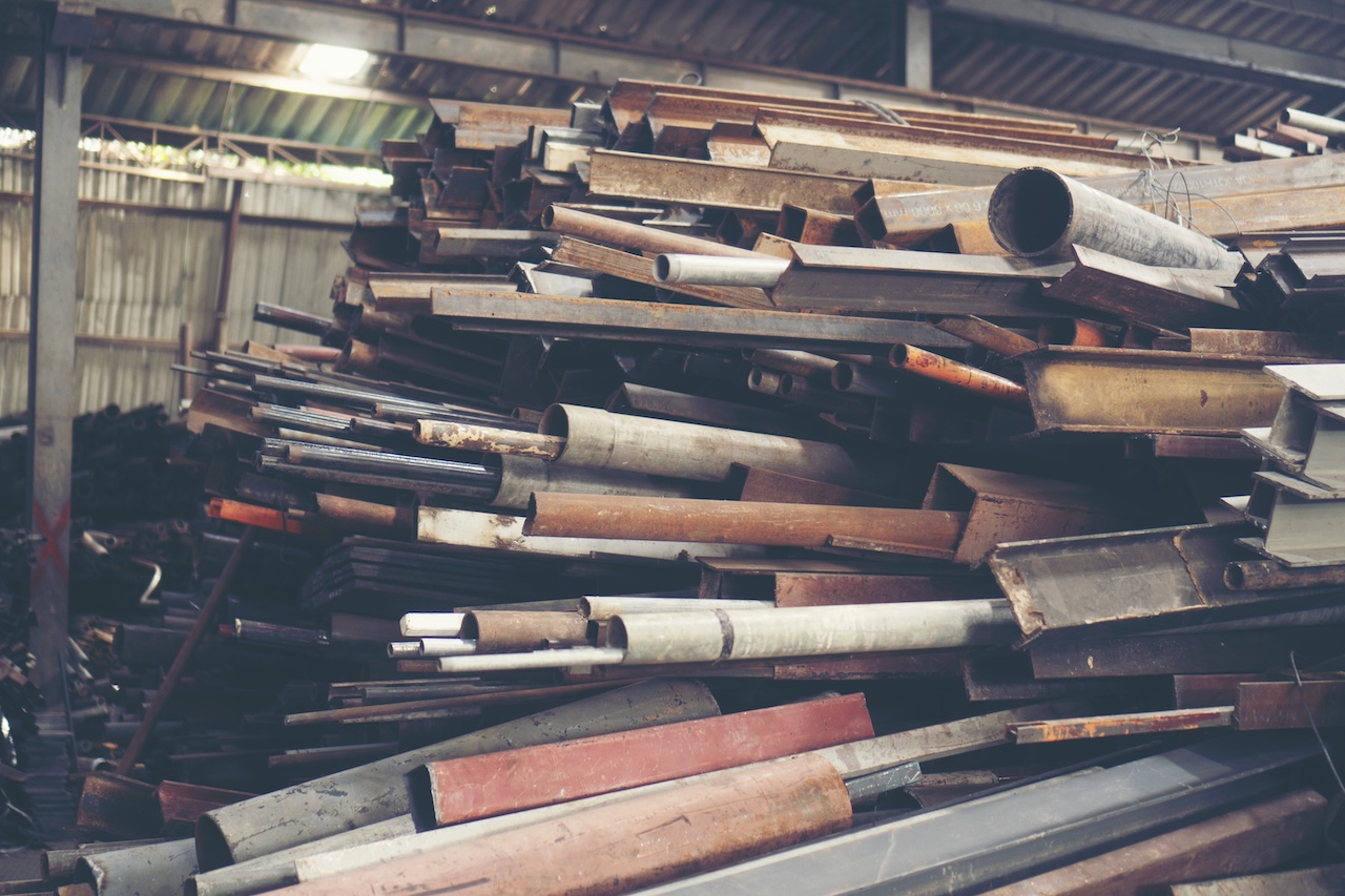 Stack of steel pipes in metal factory shop